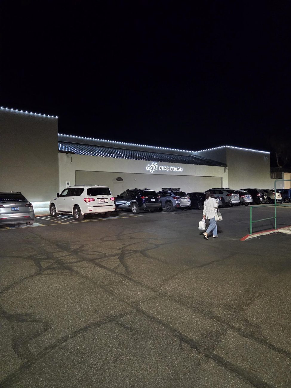 Bright white C9 LED lights running along a grocery store roofline.